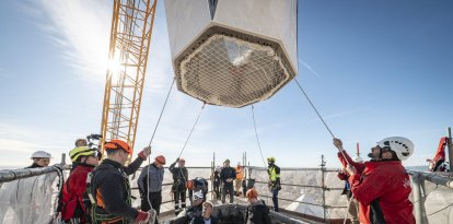 Operaris de la Sagrada Família posant l'últim bloc de la torre de Jesús.