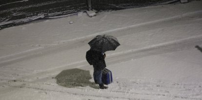 Un vianant protegint-se de la neu.