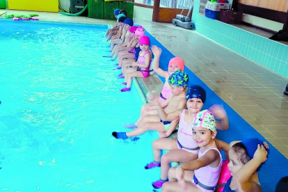 Els d'infantil de l'escola Mare Janer van viure el seu primer dia a la piscina remullant-se els peus en grup i aprenent tècniques de natació tots junts.