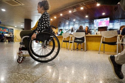 Una dona en cadira de rodes a l’edifici administratiu del Govern.