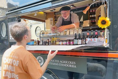 Un ciutadà comprant al food truck del mercat.