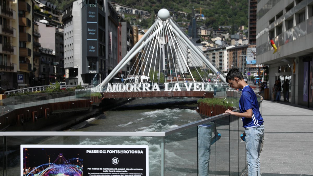 Un jove observant el pas del riu a l’altura de la Rotonda d’Andorra la Vella.