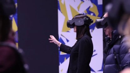 Diverses persones gaudint de l'exposició d'una forma immersiva, gràcies a les ulleres de realitat virtual.