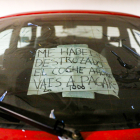 Un cartell escrit pel propietari d’un cotxe destrossat.