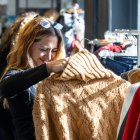 Una dona s’interessa per un jersei.