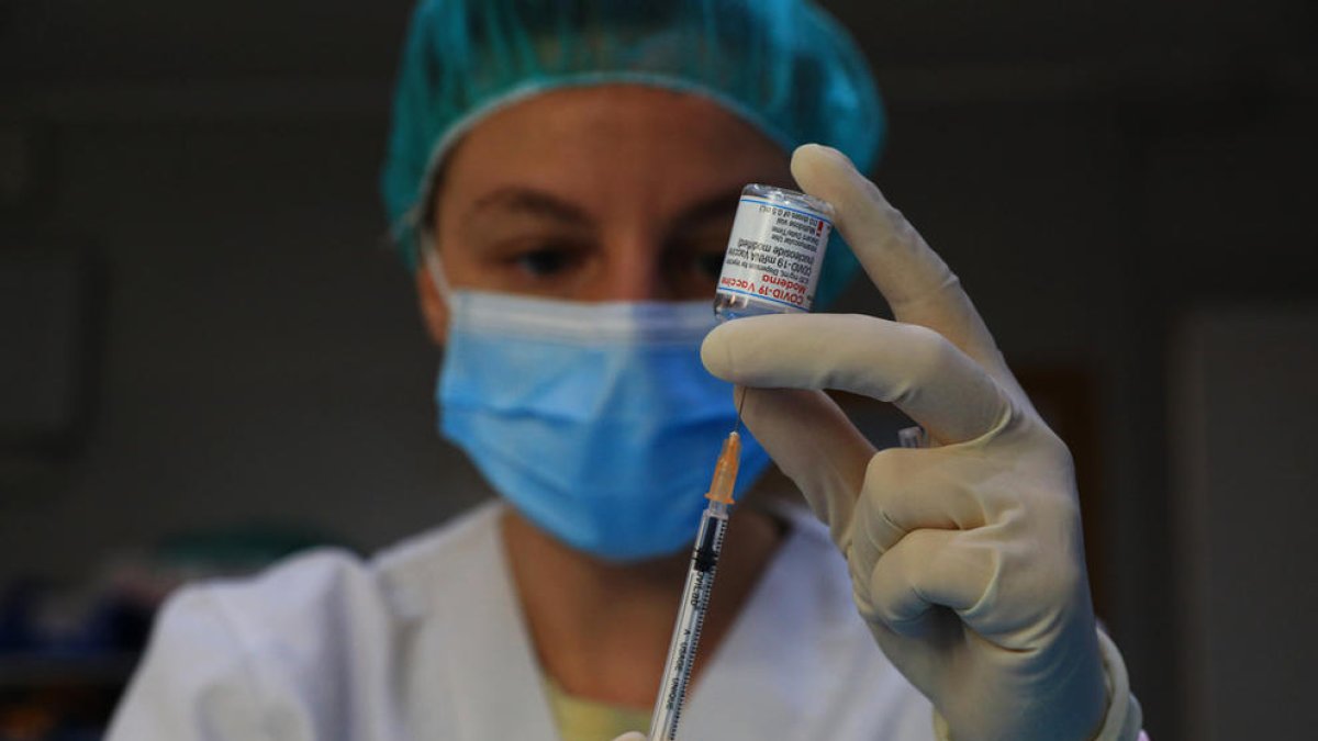 Una infermera manipulant un vaccí.