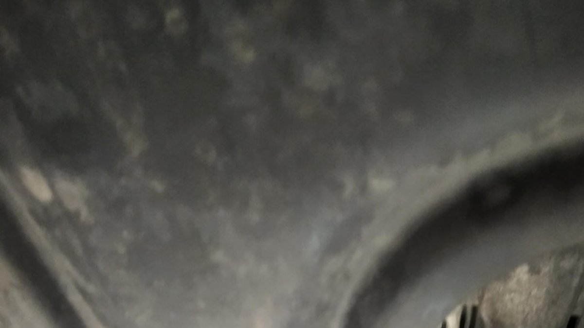 Els baixos d'un vehicle vistos des de la fosa d'un taller mecànic.