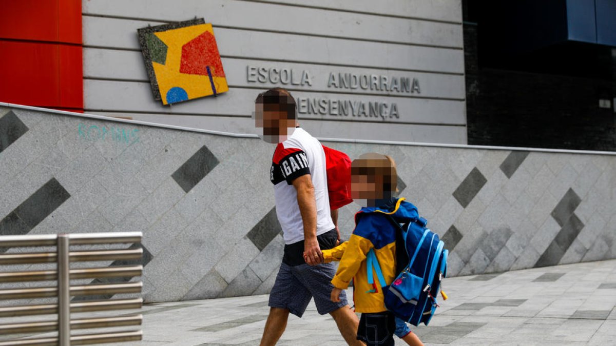 Alumnes amb un acompanyant el primer dia d'escola.
