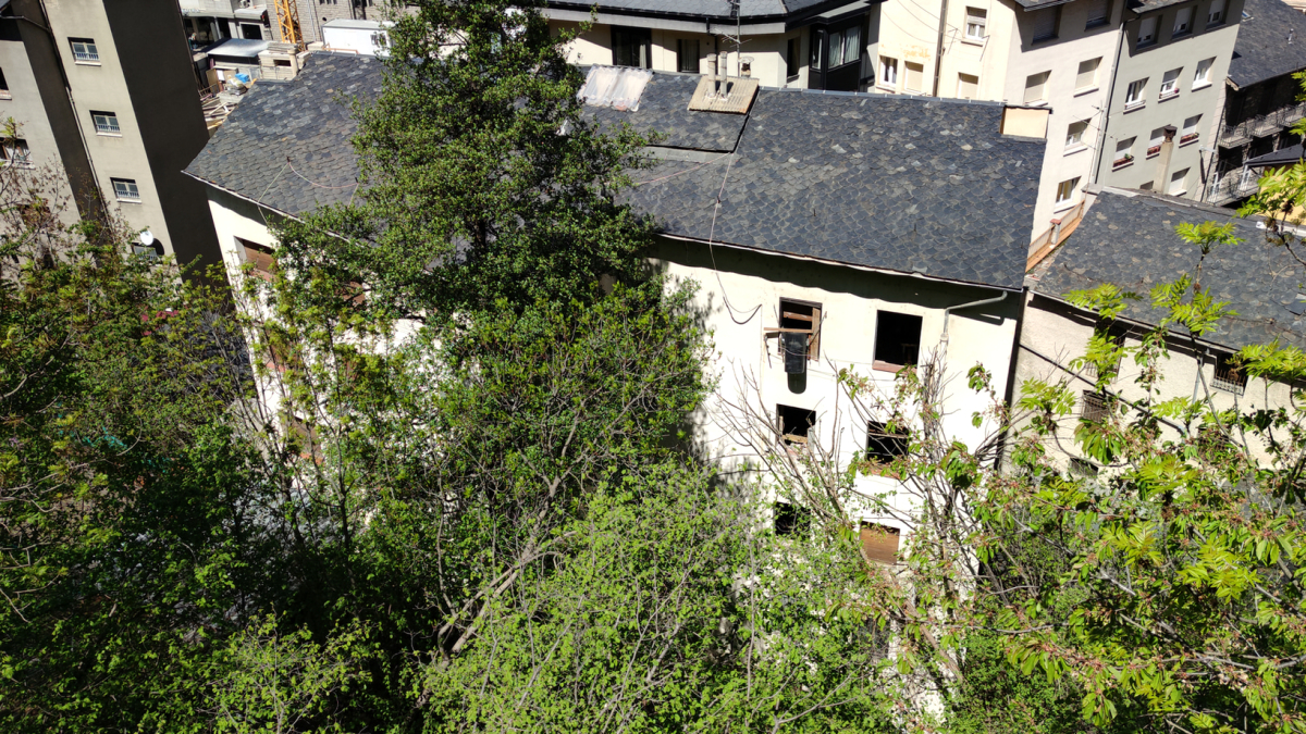 Part posterior de la casa on es veuen les finestres sense tancaments.