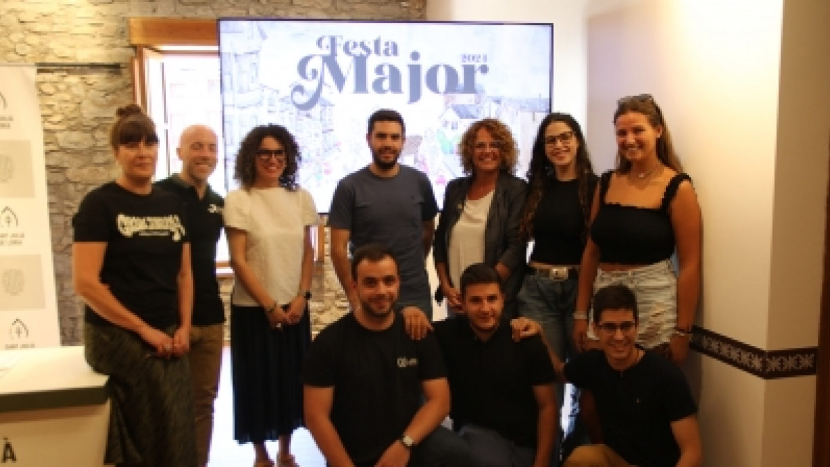 Els organitzadors de la Festa Major davant del cartell.