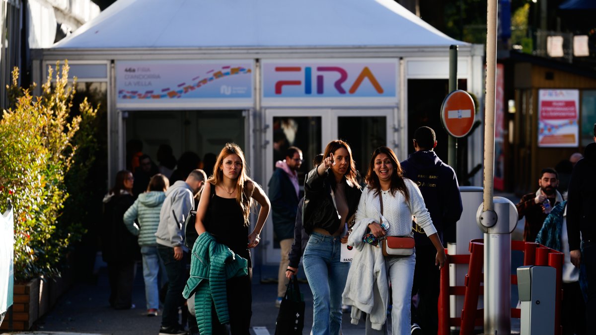 Tres persones sortint de la carpa de la Fira d’Andorra la Vella.