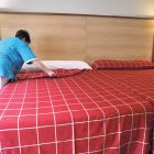 Una cambrera d’hotel fa el llit.