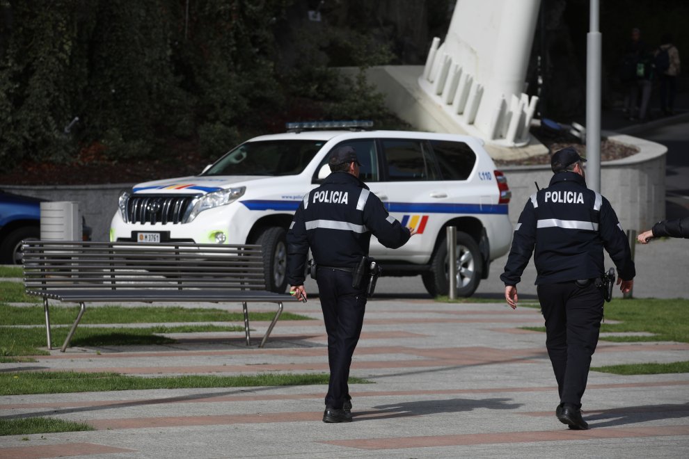 Two police officers are patrolling a street.