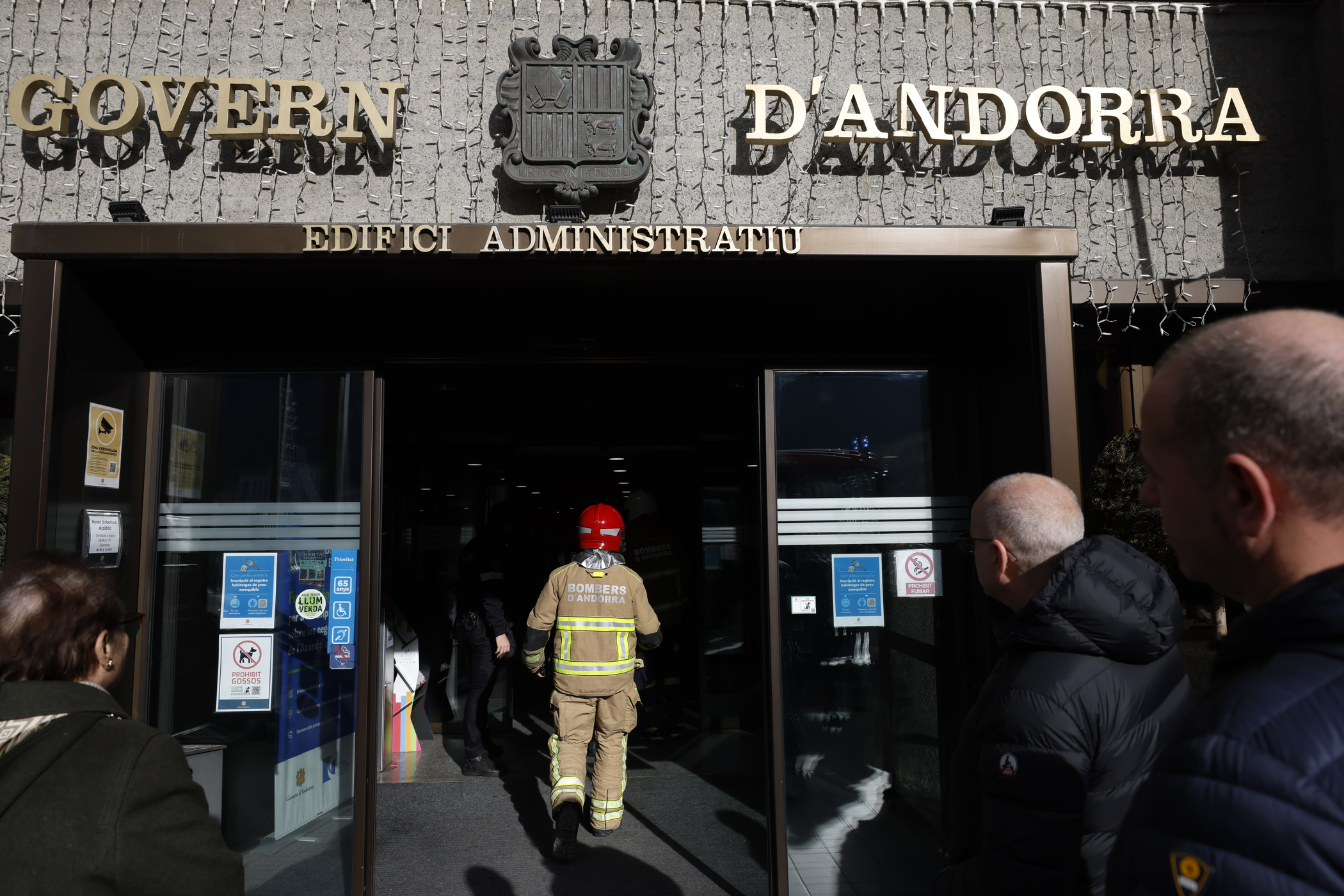 A firefighter enters the administrative building of the Government.