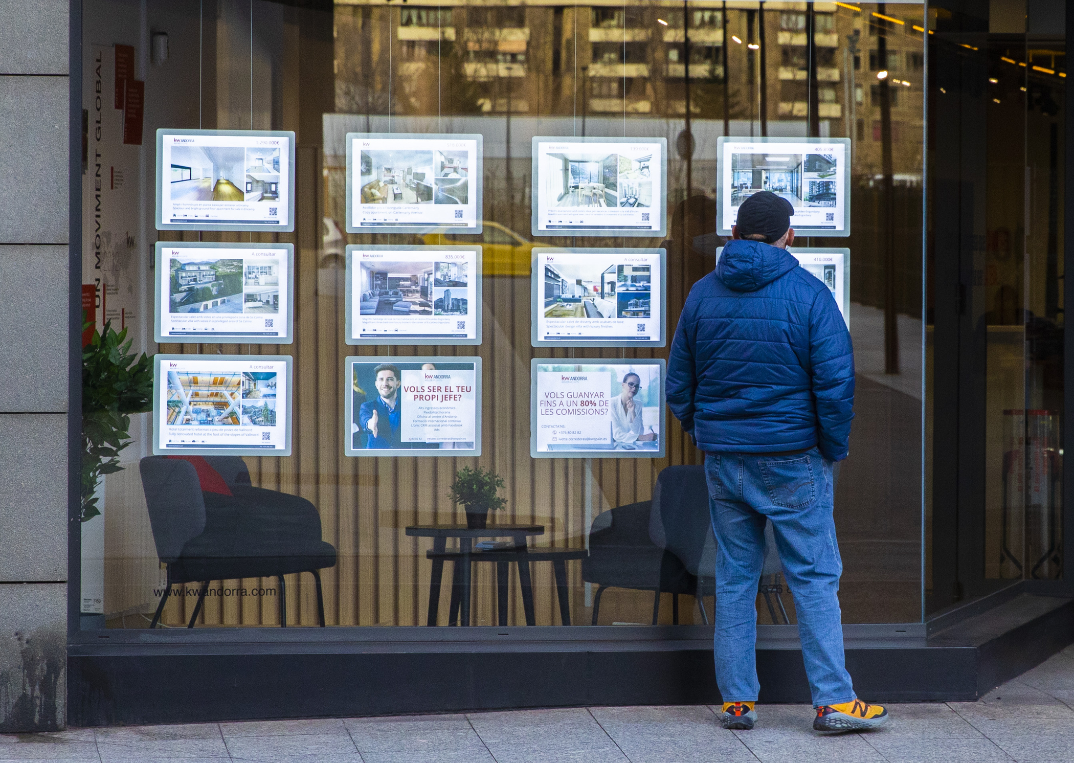 A man consults the ads of a real estate agency.