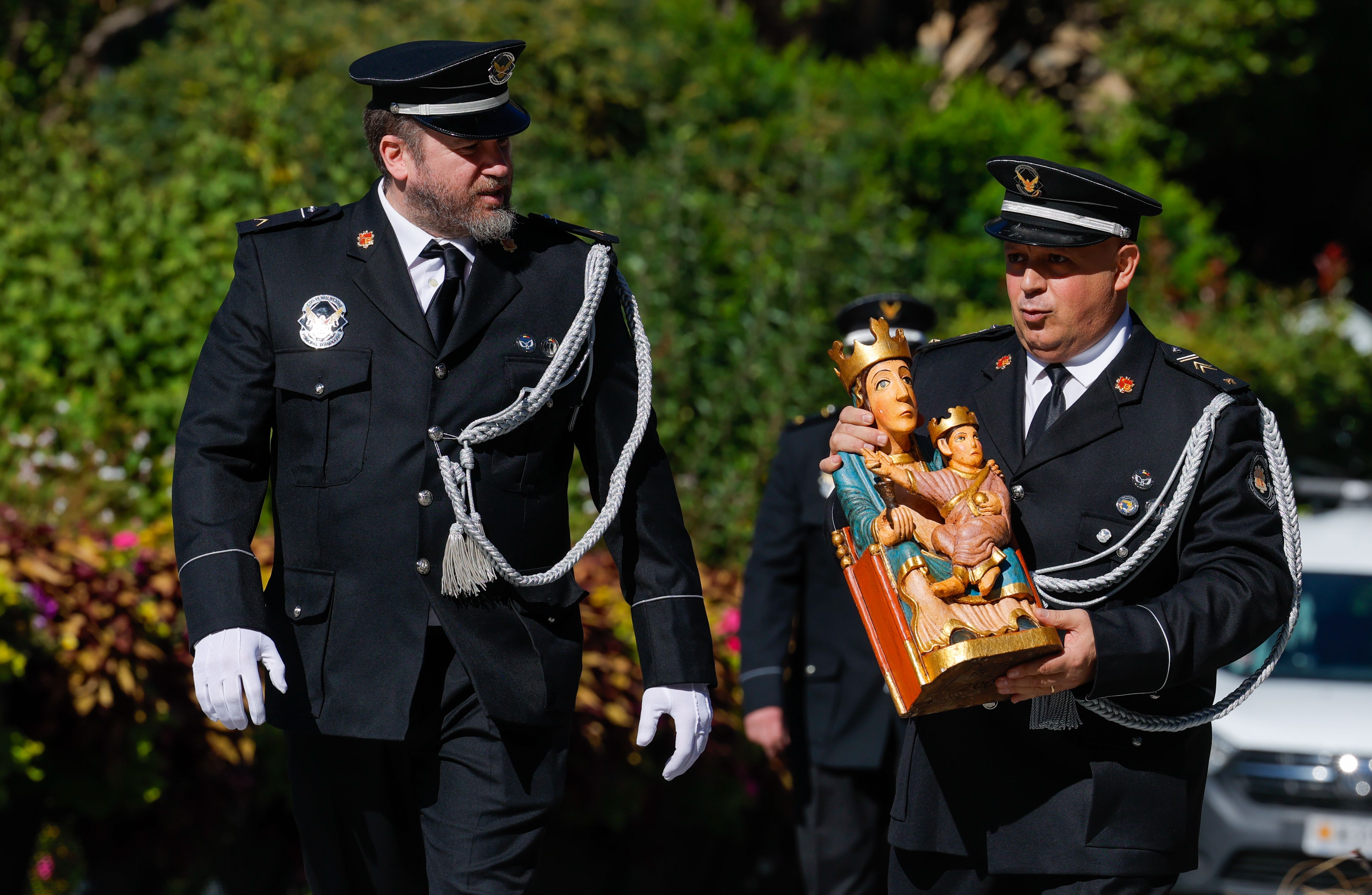 Two prison officials with Our Lady of Remei, their patron.
